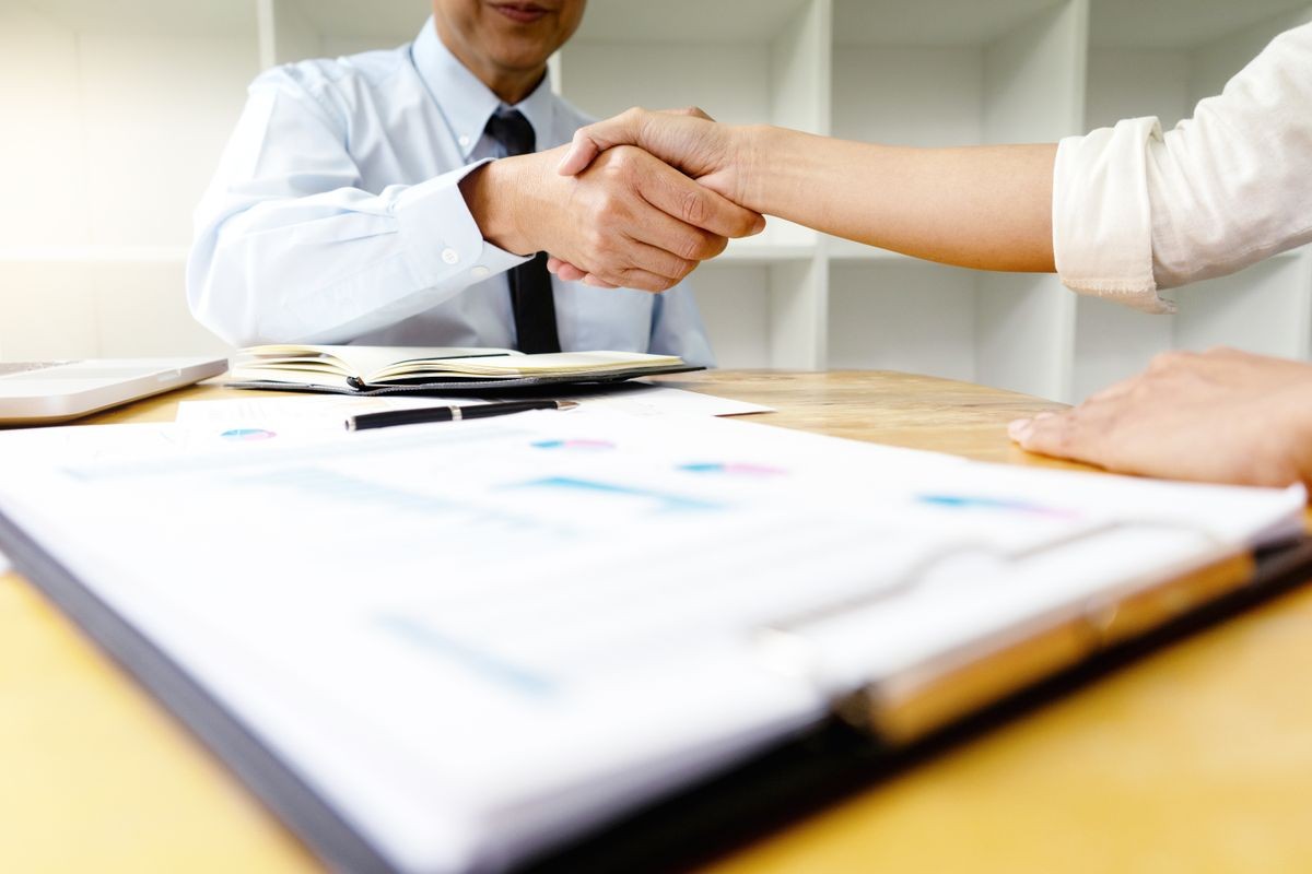 Two Business handshake and business people after discussing good deal of Trading contract and new projects for both companies, success, partnership, co worker . Meeting and greeting concept.